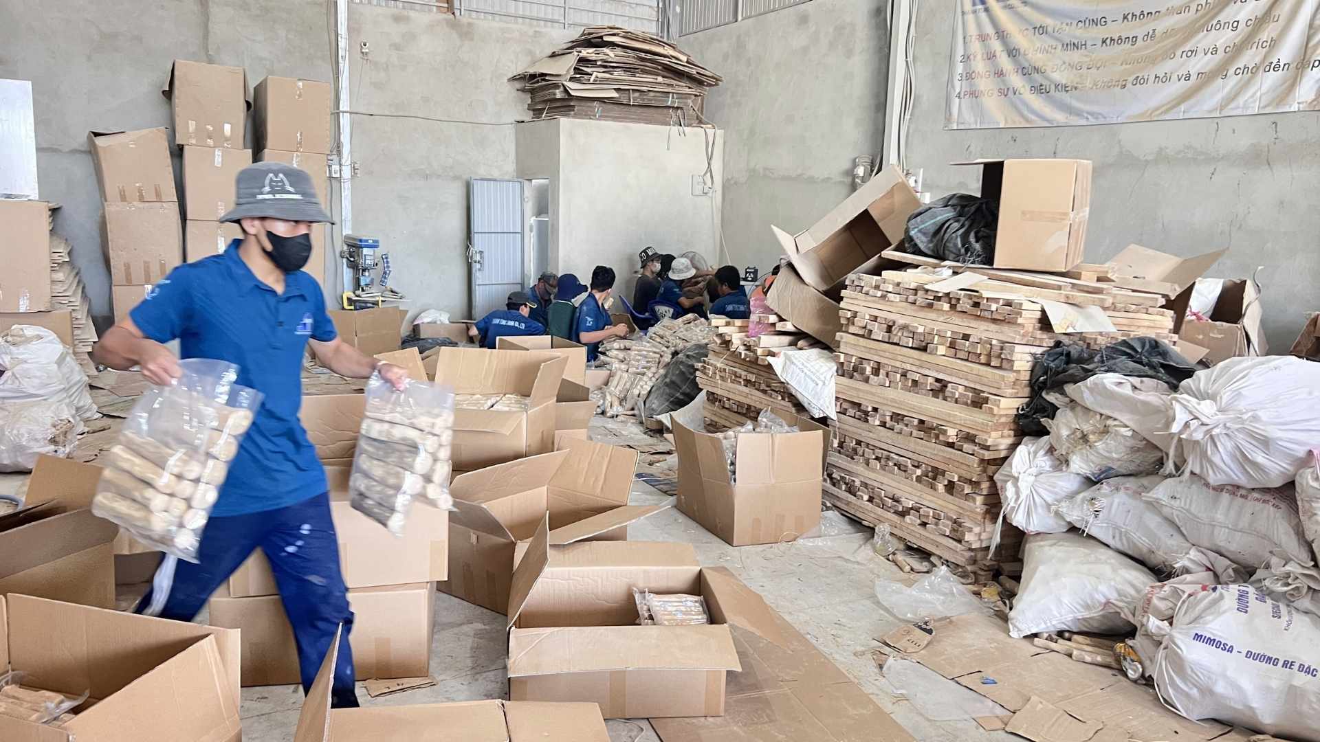 Team members at the Vietnam-based wooden factory packing goods for international orders.