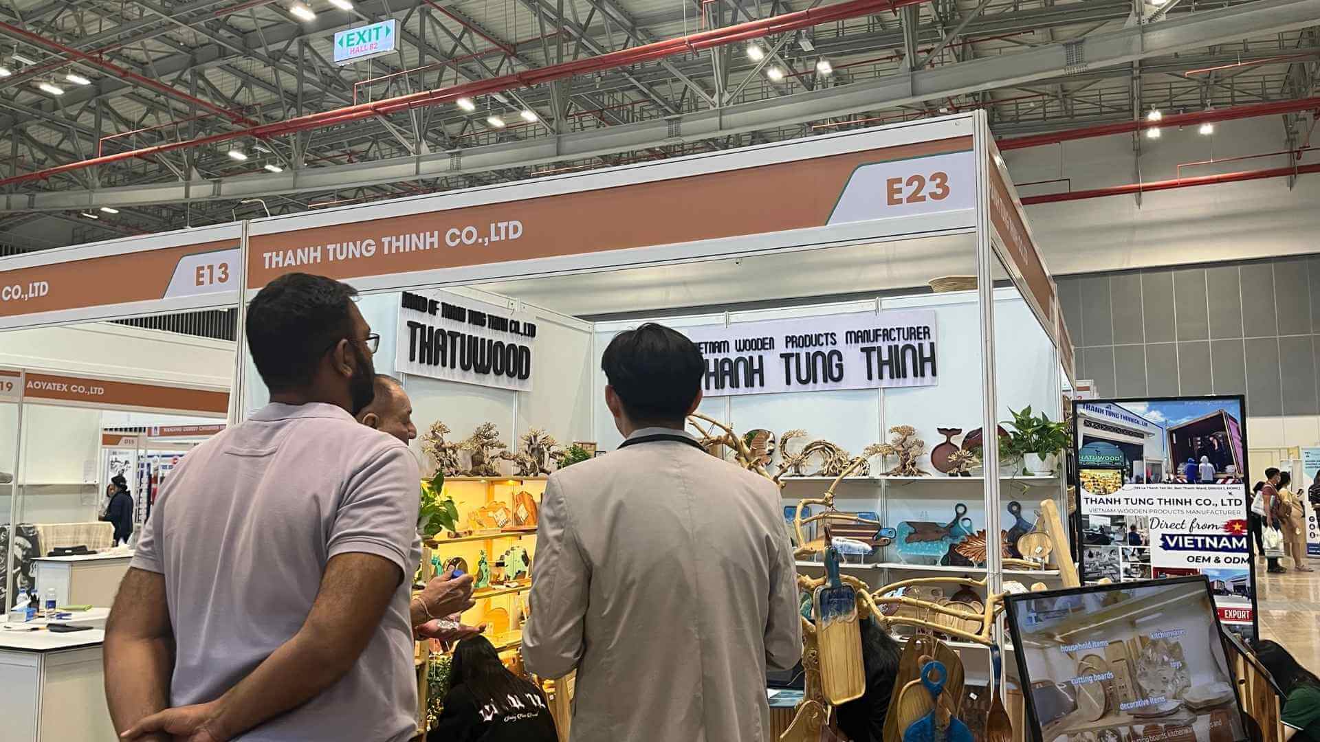 Wooden product manufacturers showcasing their offerings at an international trade show.