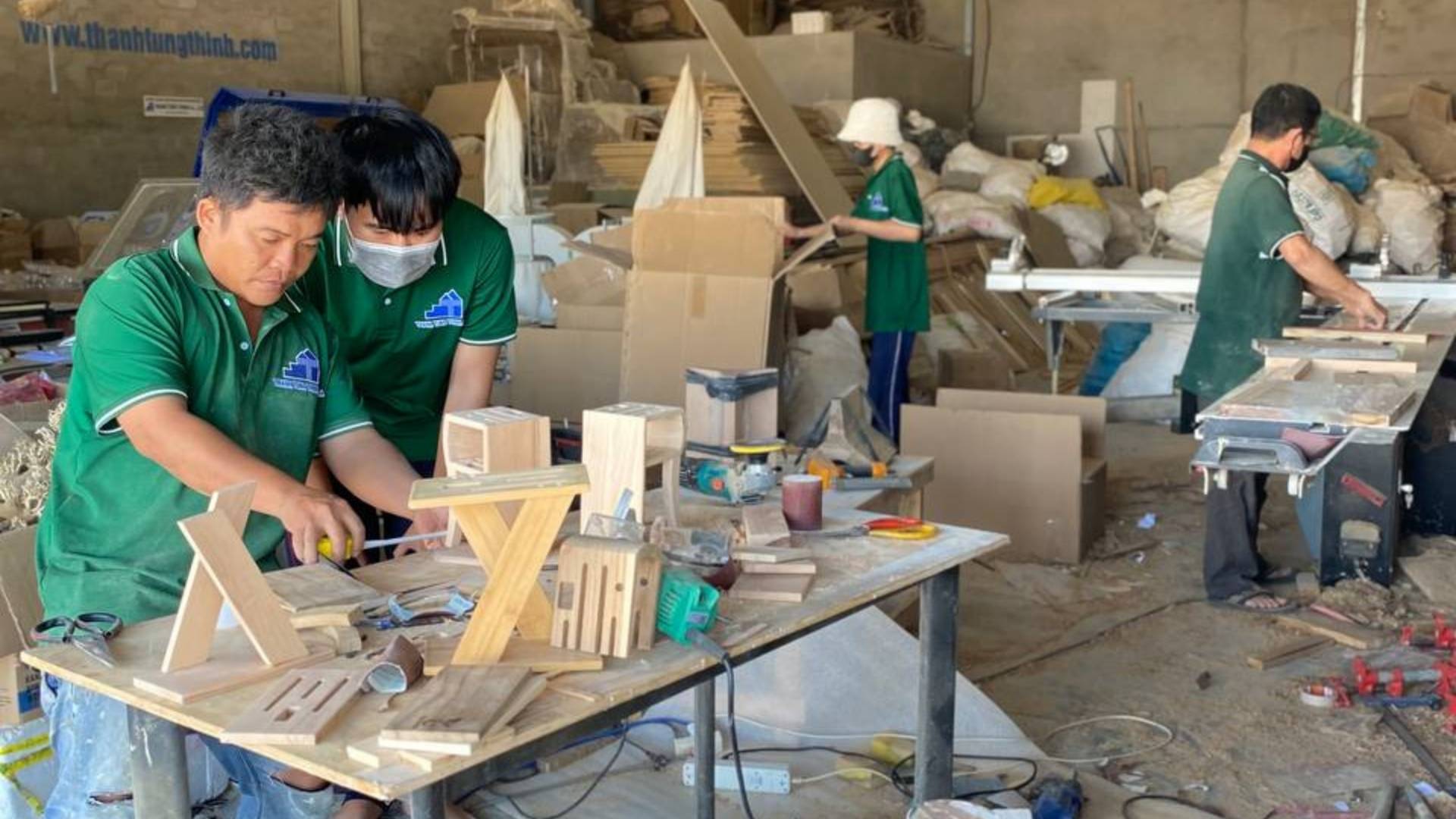 Workers in a woodworking factory manufacturing wooden kitchenware products