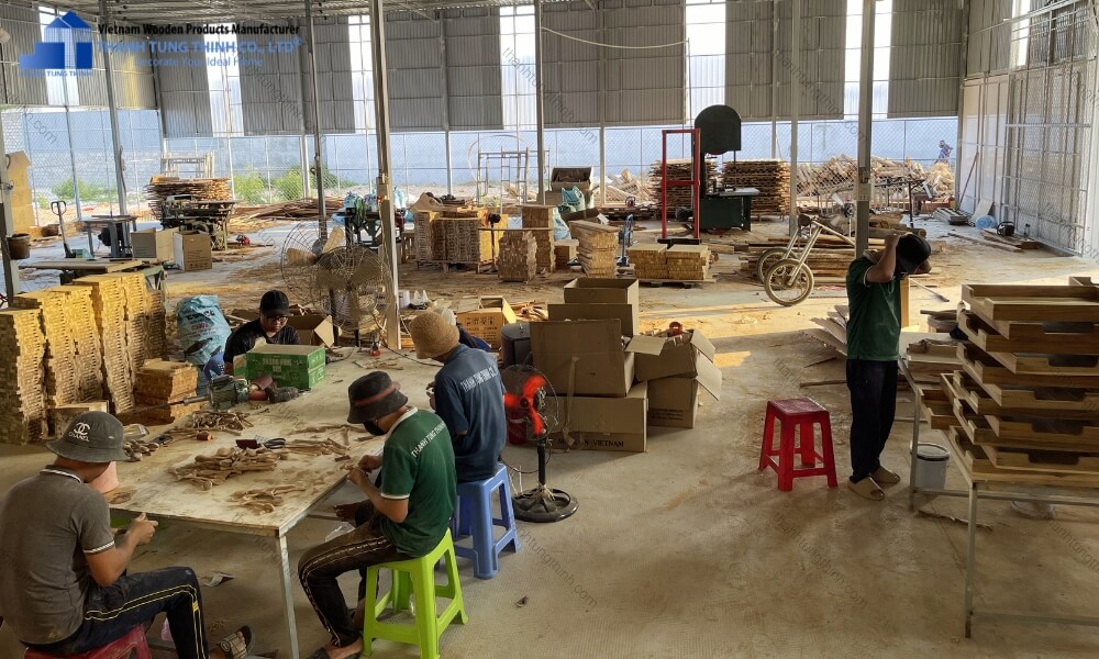 Skilled carpenters working at Thanh Tung Thinh's wooden cutting board factory in Binh Thuan province, Vietnam.
