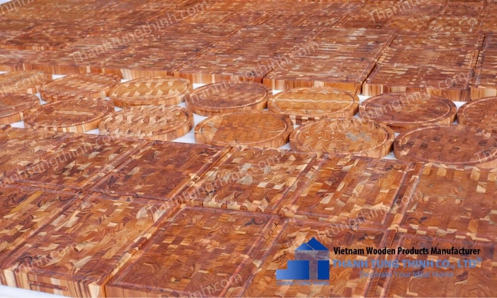 Teak wood cutting boards stacked and ready for wholesale distribution