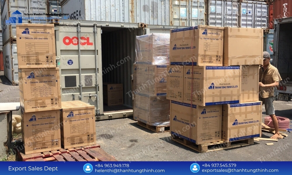 Factory staff arranging branded export cartons near an open shipping container for a bulk buy teak chopping boards order