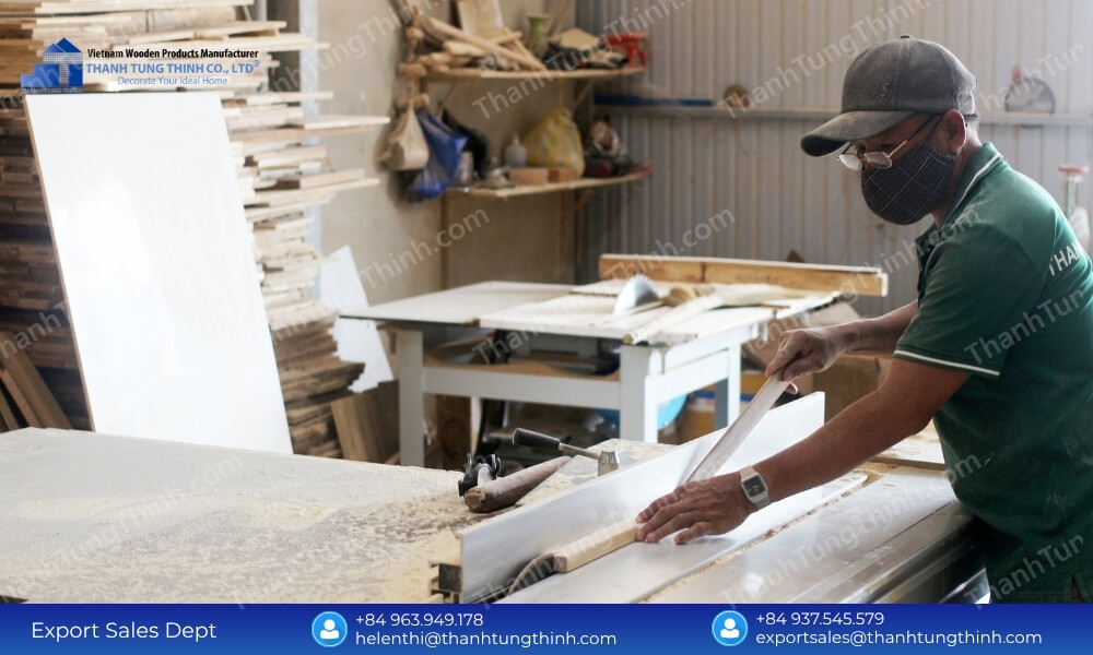 A factory worker carefully smoothing out edges to meet global export standards for a teak wood cutting board supplier.