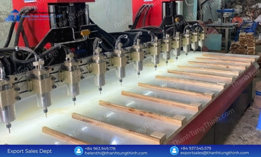 A high-precision multi-head CNC routing machine processing multiple wooden planks lined up on an automated assembly line