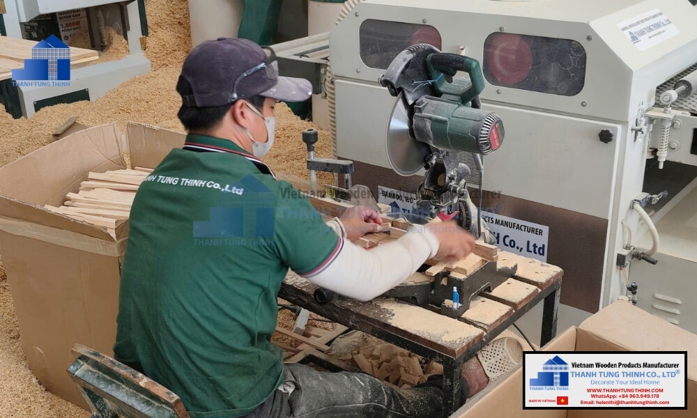 A skilled craftsman cutting wood blanks at a certified bulk wooden plates factory manufacturing facility