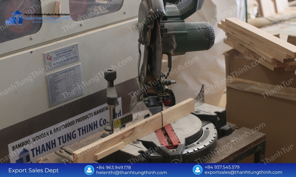 Industrial timber cutting machine inside the facility of a wholesale wooden bowls manufacturer