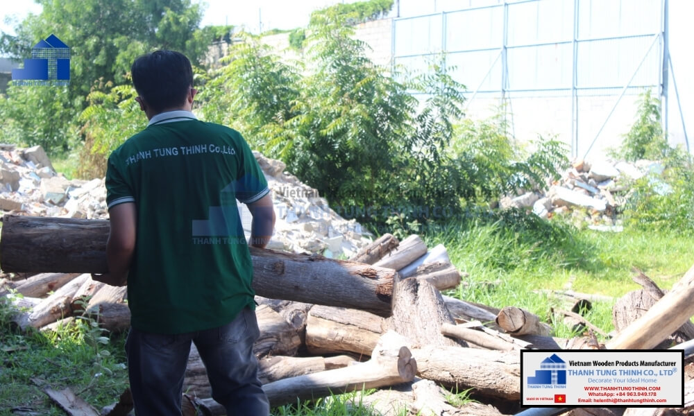 factory worker handling raw materials for fsc certified wood bowls