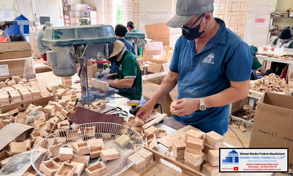 Artisans crafting small wooden jewelry boxes at ThanhTungThinh factory workshop