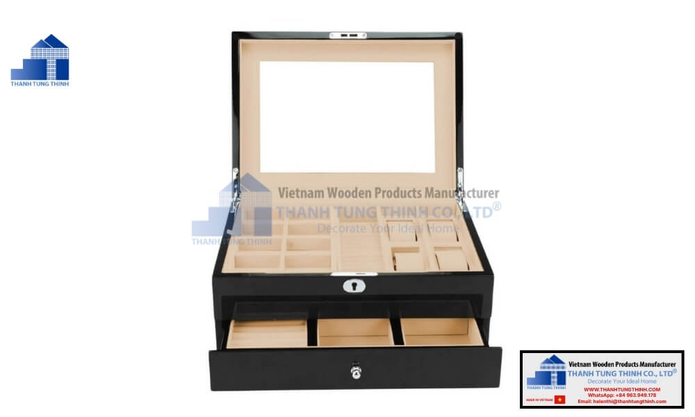 Open layout of a black wooden jewelry box showcasing ring rolls and drawers