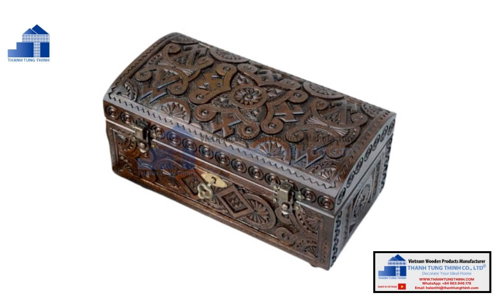 Vintage carved wood storage chest alongside a classic black wooden jewelry box