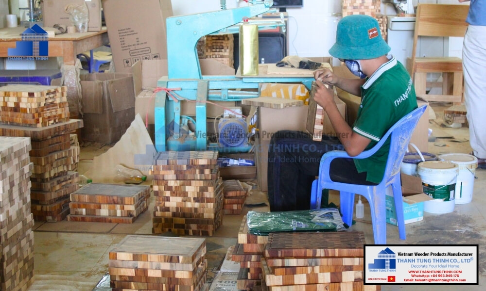 Skilled artisan crafting the best end-grain wooden cutting boards in Vietnam factory